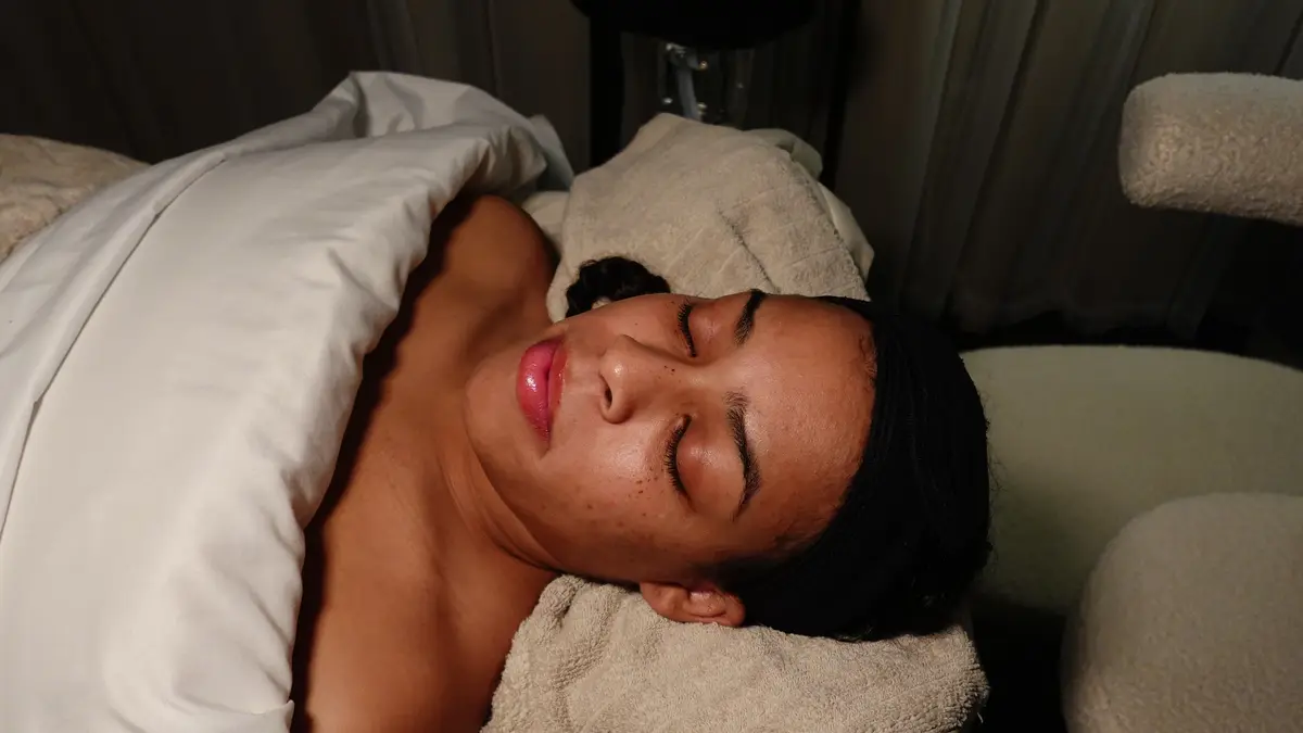Esthetician assessing a client's skin before a Luxe Skin Reset Facial in Memphis