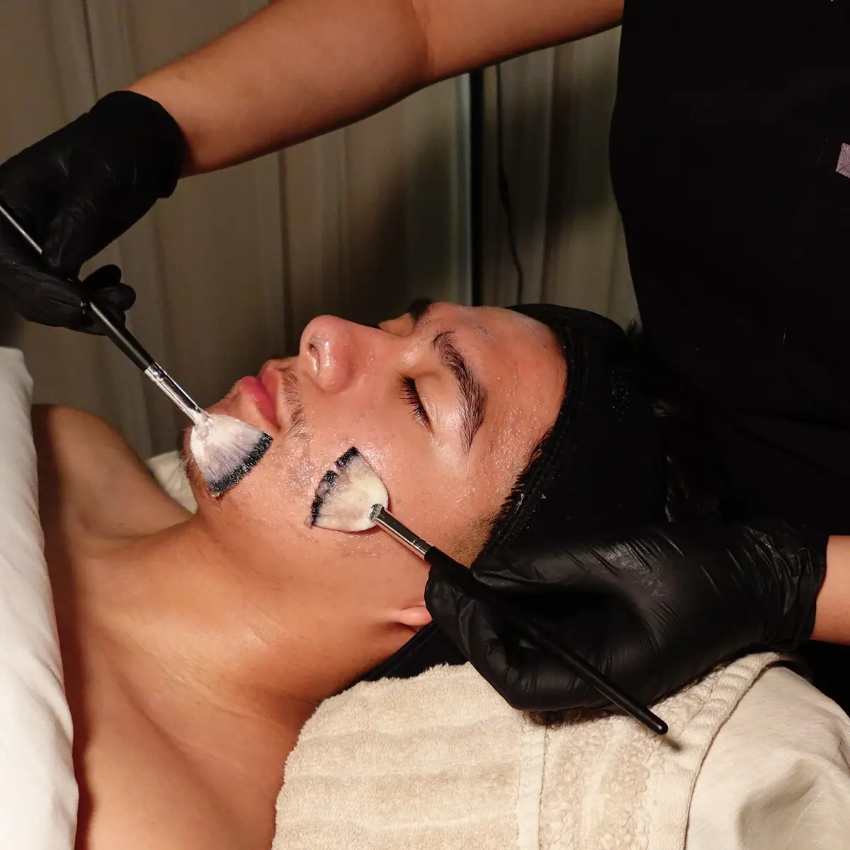 Customized treatment mask being applied during the Gentleman's Skin Reset Facial